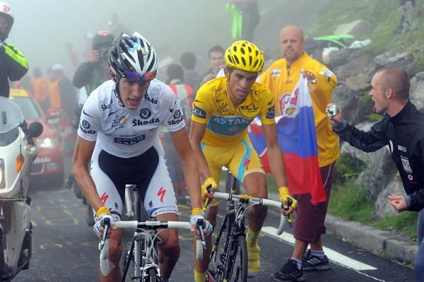 Schleck and Contador thread their way through the fans.