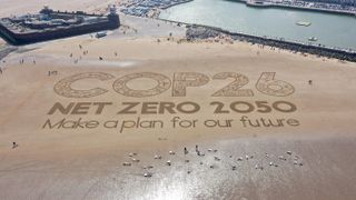 A giant sand artwork adorns New Brighton Beach to highlight global warming and the forthcoming COP26 global climate conference being held in November in Glasgow.