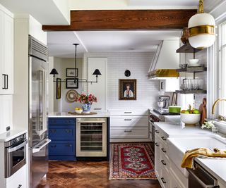 kitchen with white cabinets and blue island