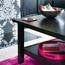 living room with black coffee table wallpaper pink rug