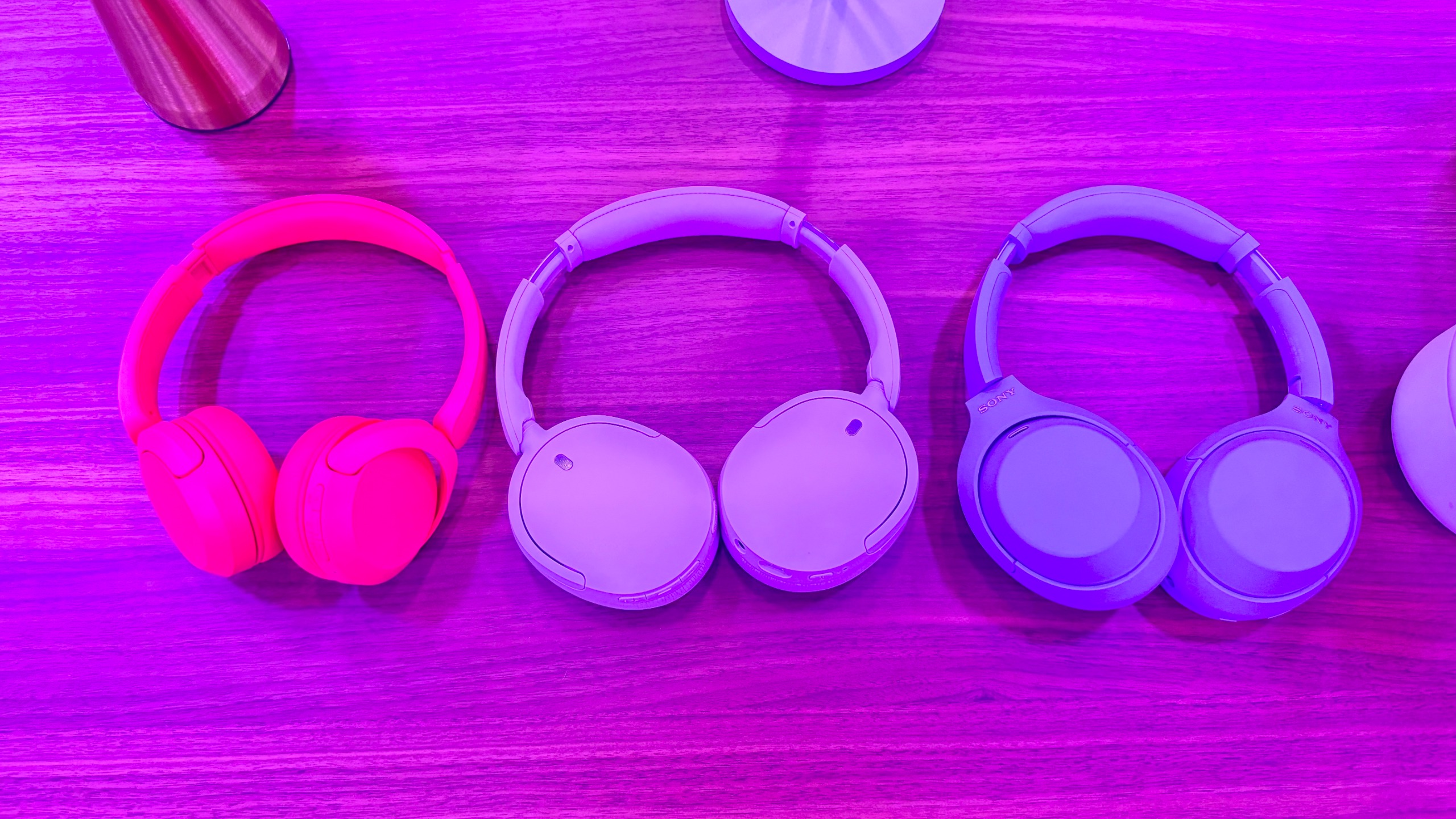 Sony WH-CH730N wireless headphones in lavender on a wooden table