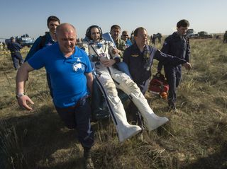 NASA astronaut Rick Mastracchio is carried in a chair to a medical tent just after returning to Earth aboard a Soyuz TMA-11M near the town of Zhezkazgan, Kazakhstan on May 14, 2014.