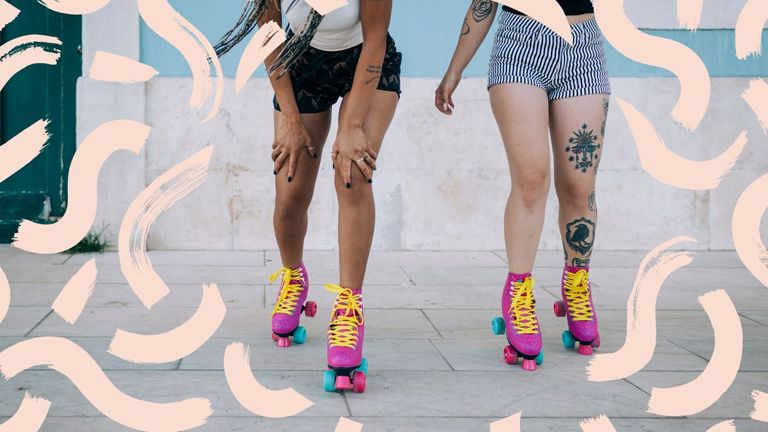 two women roller skating with a patterned background