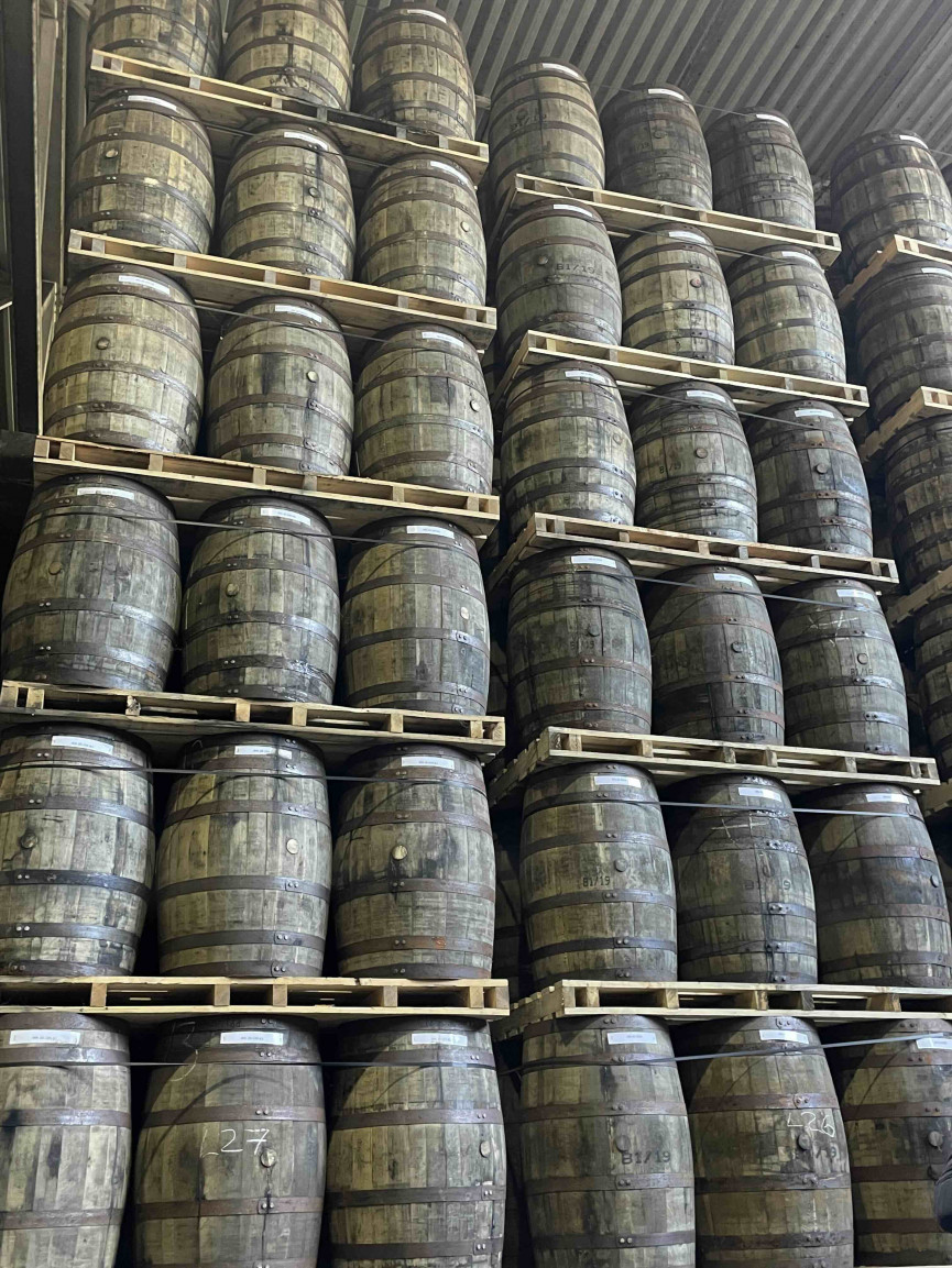 Barrels stacked high in a warehouse