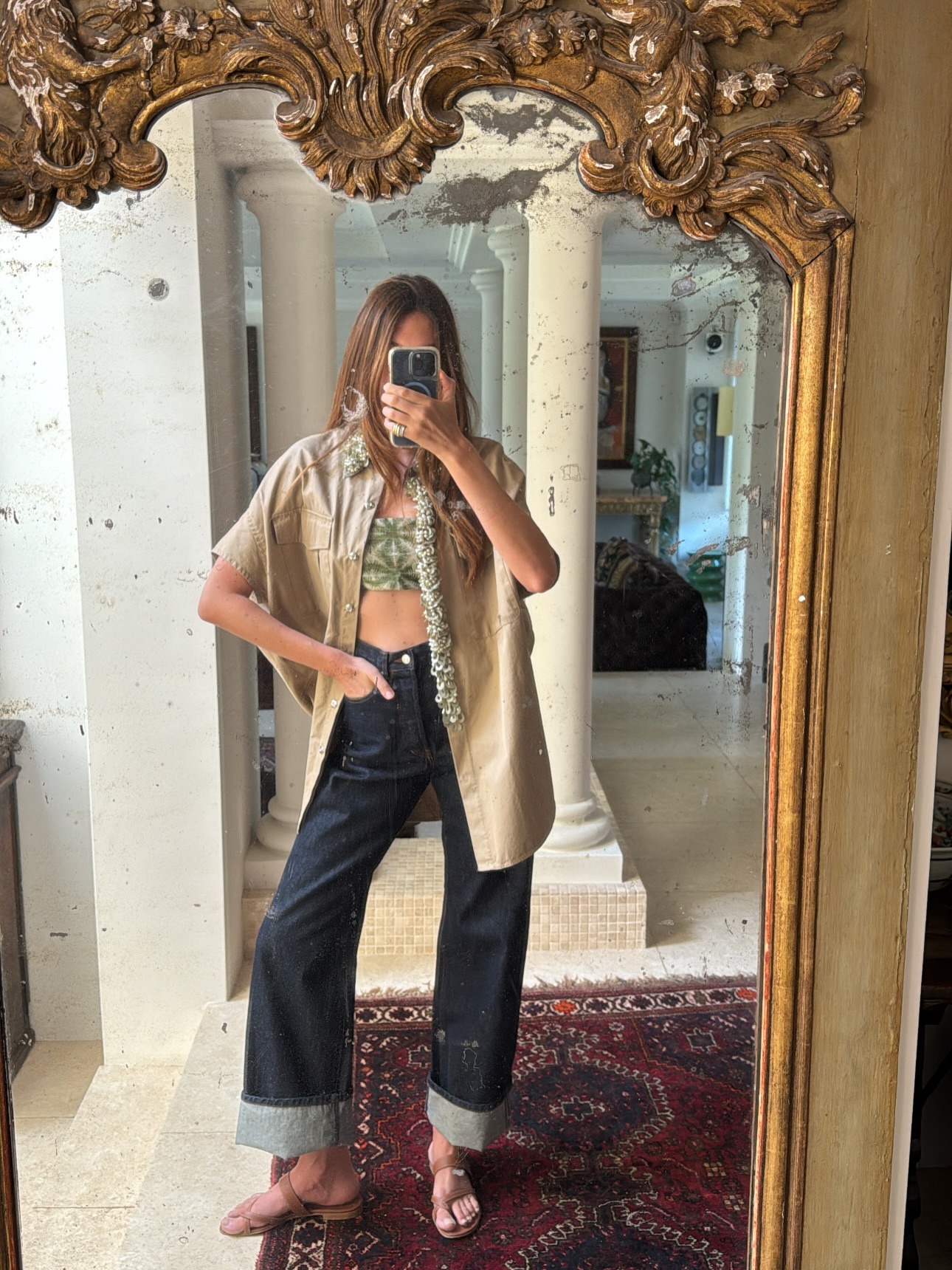 Fashion person Sara Loura wears the french girl cuffed jeans trend.