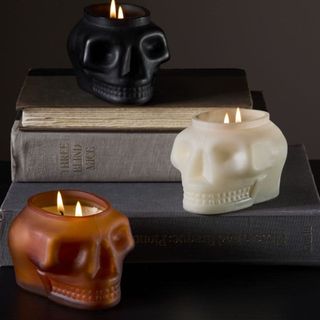 Spooky Skull Filled Glass Candles against a black background.