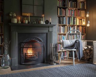 Home library ideas around fireplace by Garden Trading