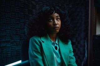 ayo edebiri wearing a green suit in a still from the movie opus