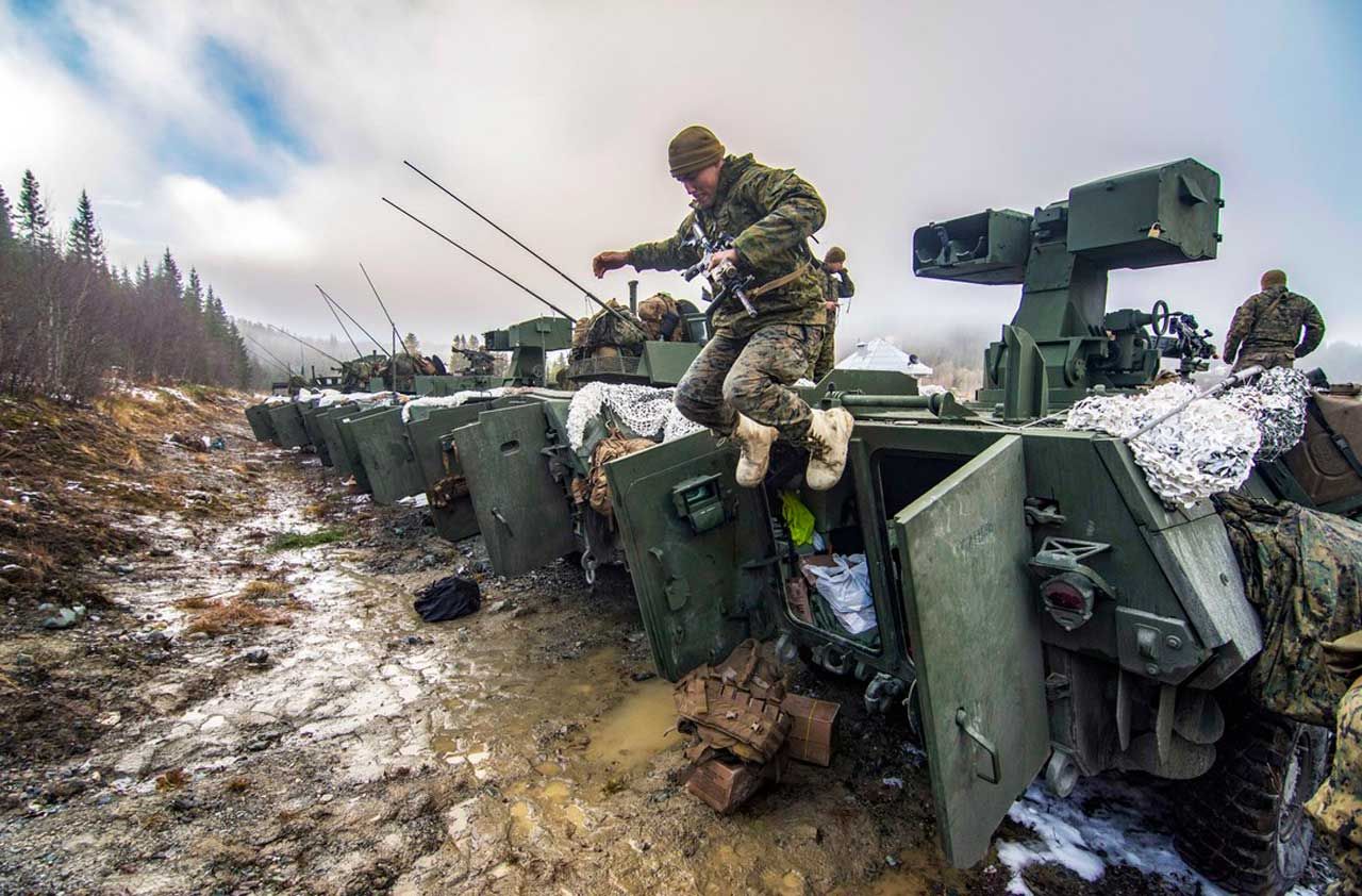 Photo of solider jumping down from armored vehicle