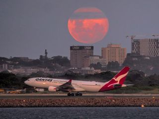 a red dot next to a full moon