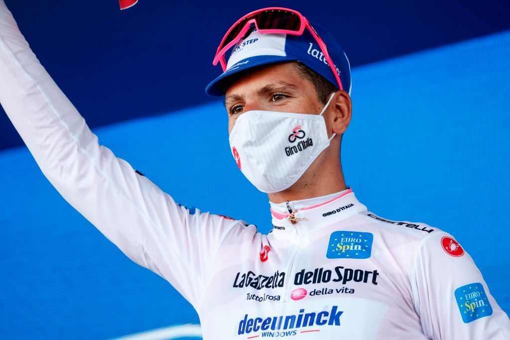 Team Deceuninck rider Portugals Joao Almeida wearing a face mask celebrates on the podium after receiving the bianca jersey in the 8th stage of the Giro dItalia 2020 cycling race a 200kilometer route between Giovinazzo and Vieste on October 10 2020 Photo by Luca Bettini AFP Photo by LUCA BETTINIAFP via Getty Images