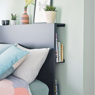 Grey bedroom with storage headboard