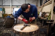 John Richard, Master Cooper at Speyside Cooperage, seals the end of a barrel using reeds. Jeremy Flint