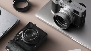 Two Fujifilm X100VI cameras in black and silver on a desk