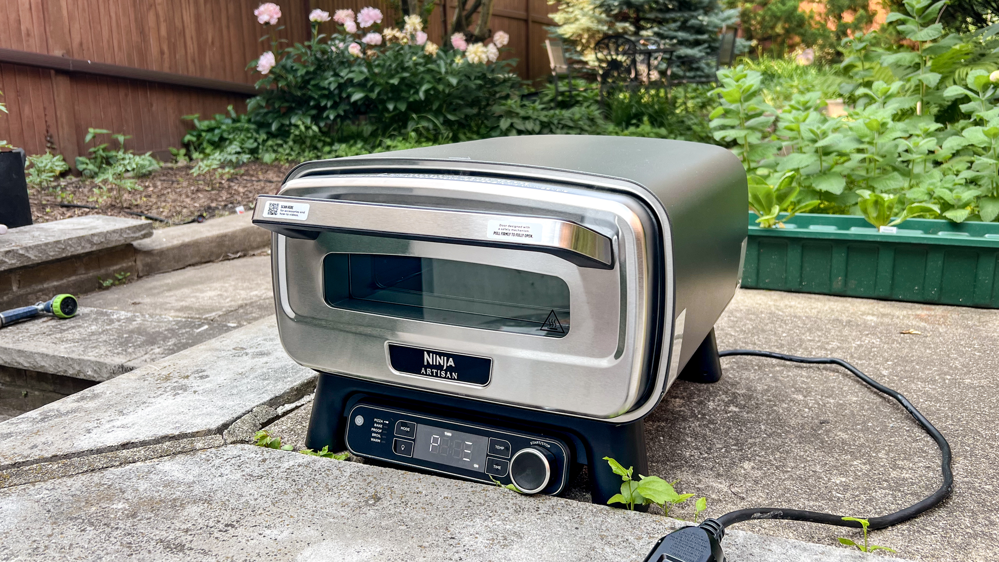 Ninja Artisan Outdoor Pizza Oven in a back yard