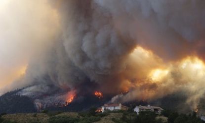 The Waldo Canyon wildfire in Colorado burns as it moves into subdivisions and destroys homes on June 26: Some Americans are drawing a direct line from global warming to this massive fire.