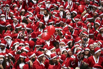 People wearing Santa Claus costumes gather to take part in the 2016 Athens Santa Run in Athens.