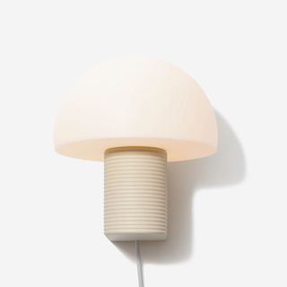 A playful plug-in sconce with rounded top