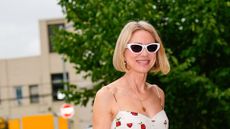 NAMOI WATTS WEARING A WHITE DRESS AND SUNGLASSES