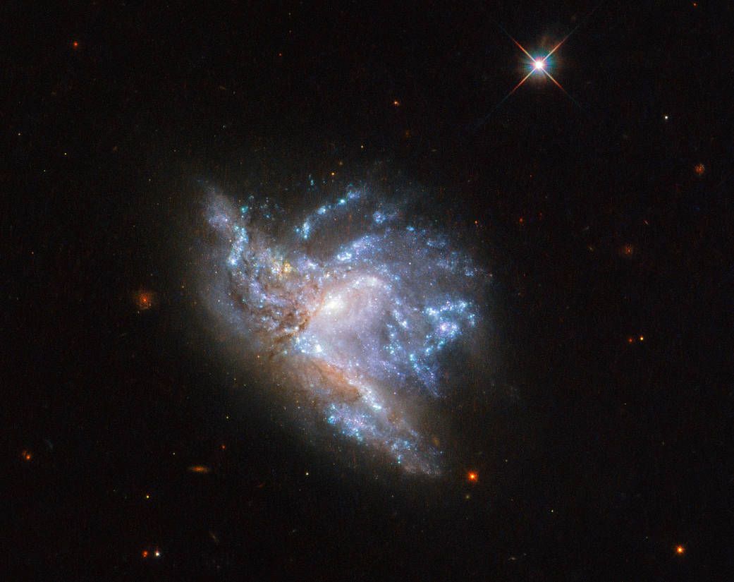 Hubble Space Telescope image of NGC 6052, a pair of colliding galaxies that lies in the constellation of Hercules, about 230 million light-years away from Earth.