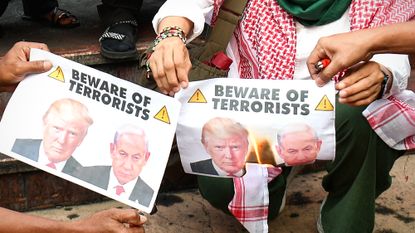 Protesters in the Philippines burn picture of U.S. President Donald Trump and Israeli Prime Minister Benjamin Netanyahu
