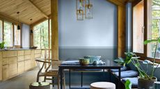 rustic dining area painted blue in a wood kitchen with assorted chairs and benches - dulux