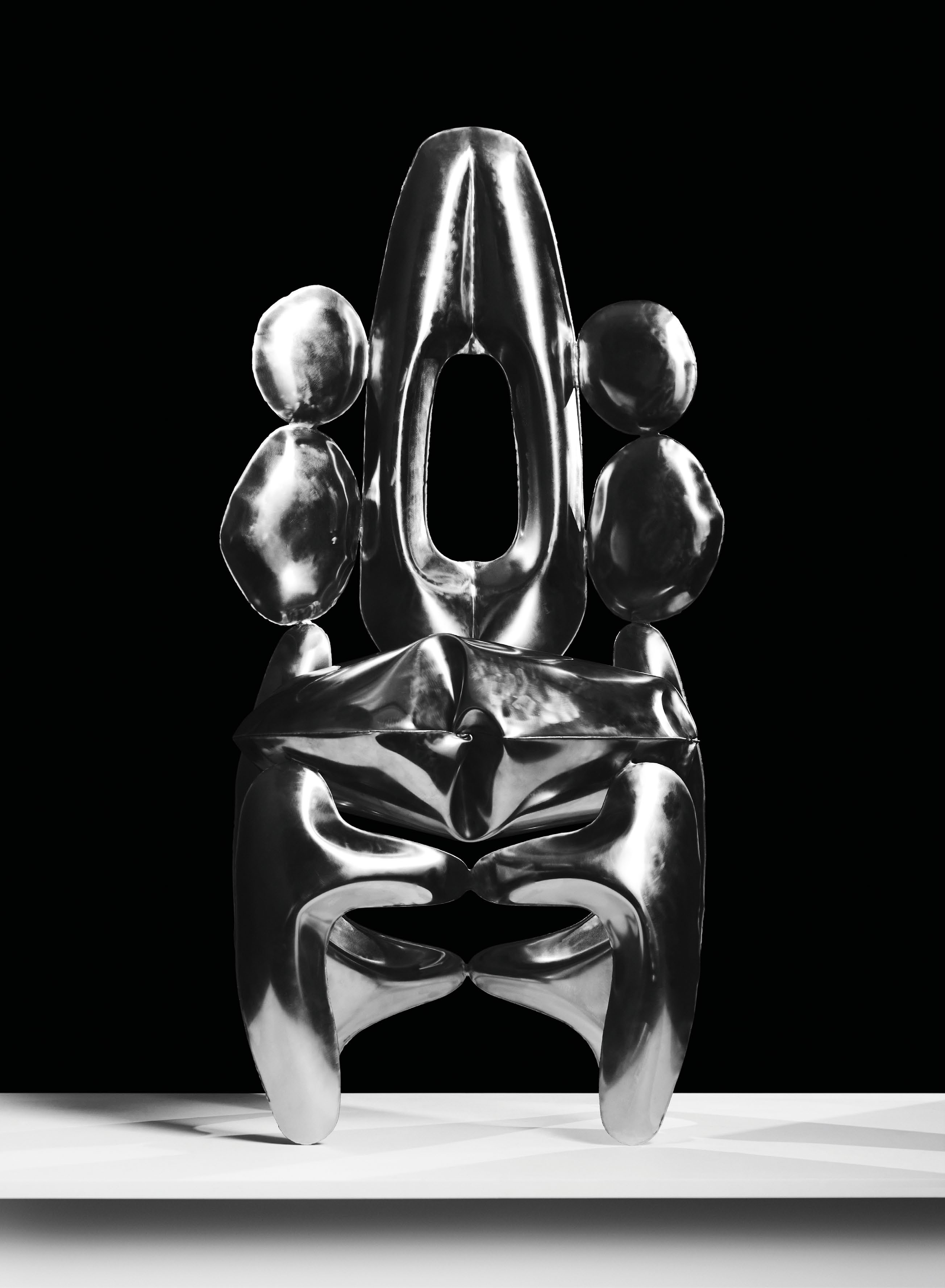 A sculptural chair by Vancouver-based artist Michelle Jiaxin Huang, showcasing a sleek, metallic design that explores the transformative qualities of steel.