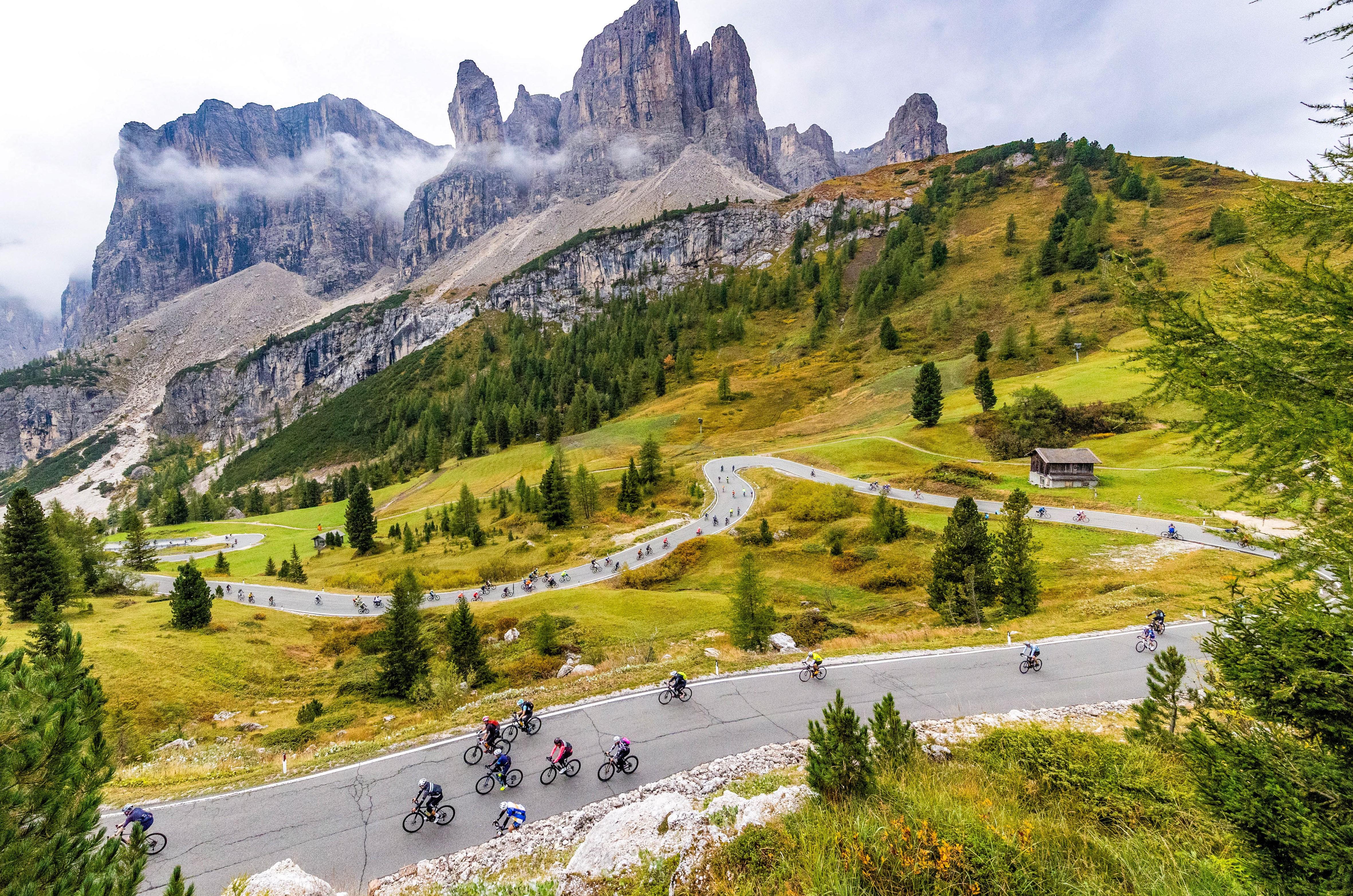 Jagged Dolomites scenery with a group of riders in the foreground
