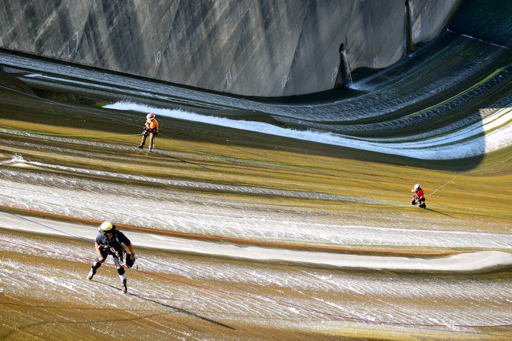 Dam-inspection workers dangle on the face of the Shasta Dam, the eighth-tallest dam in the United States.