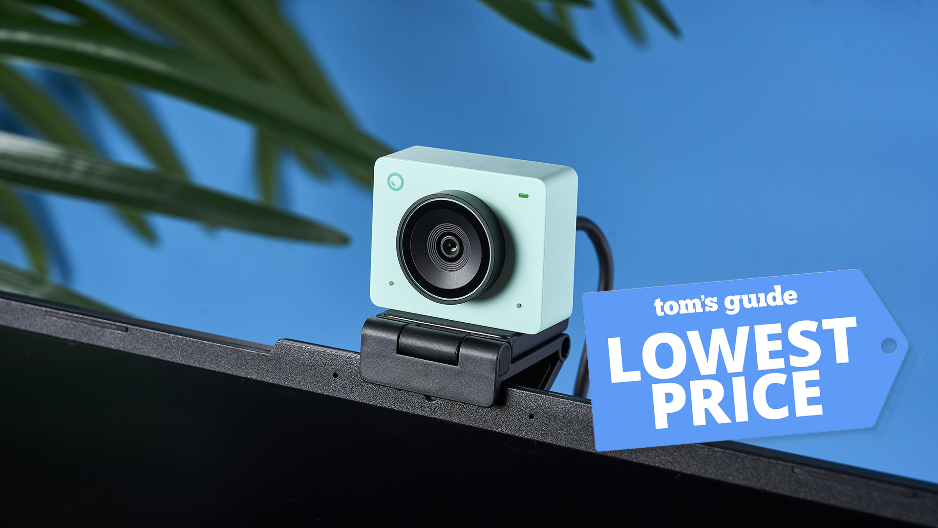 An Obsbot Meet 2 4K webcam on top of a laptop with a Tom's Guide Lowest Price deals badge on top