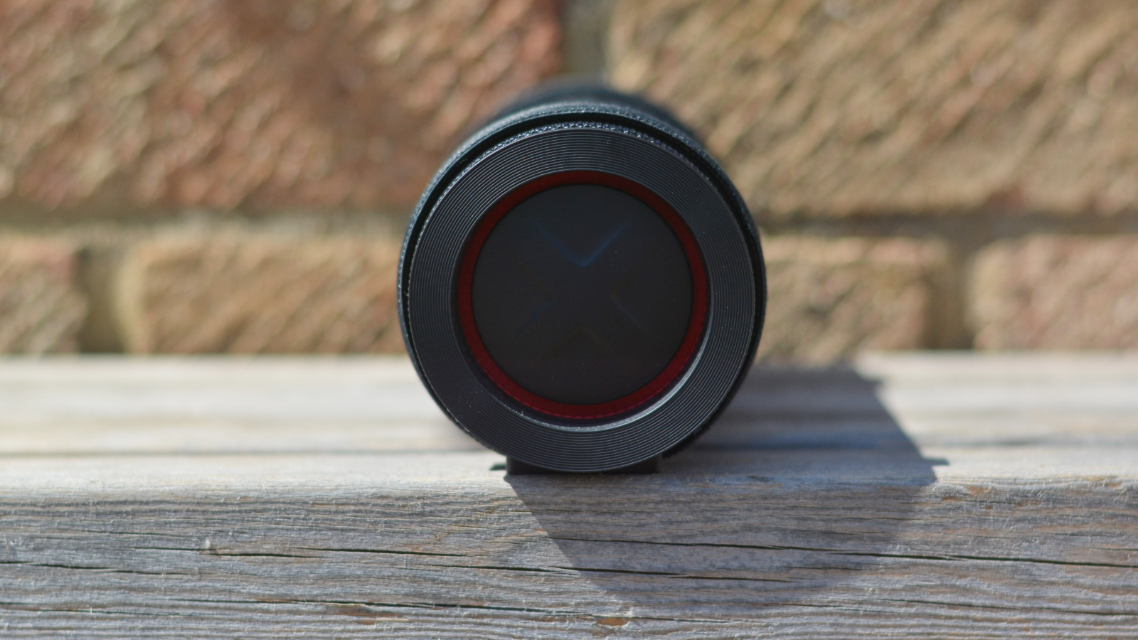 LG xboom Grab Bluetooth speaker in an outdoor setting