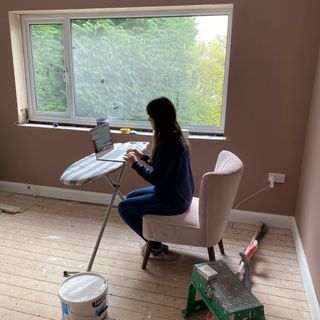 using an ironing board as a desk while living on site during a renovation project