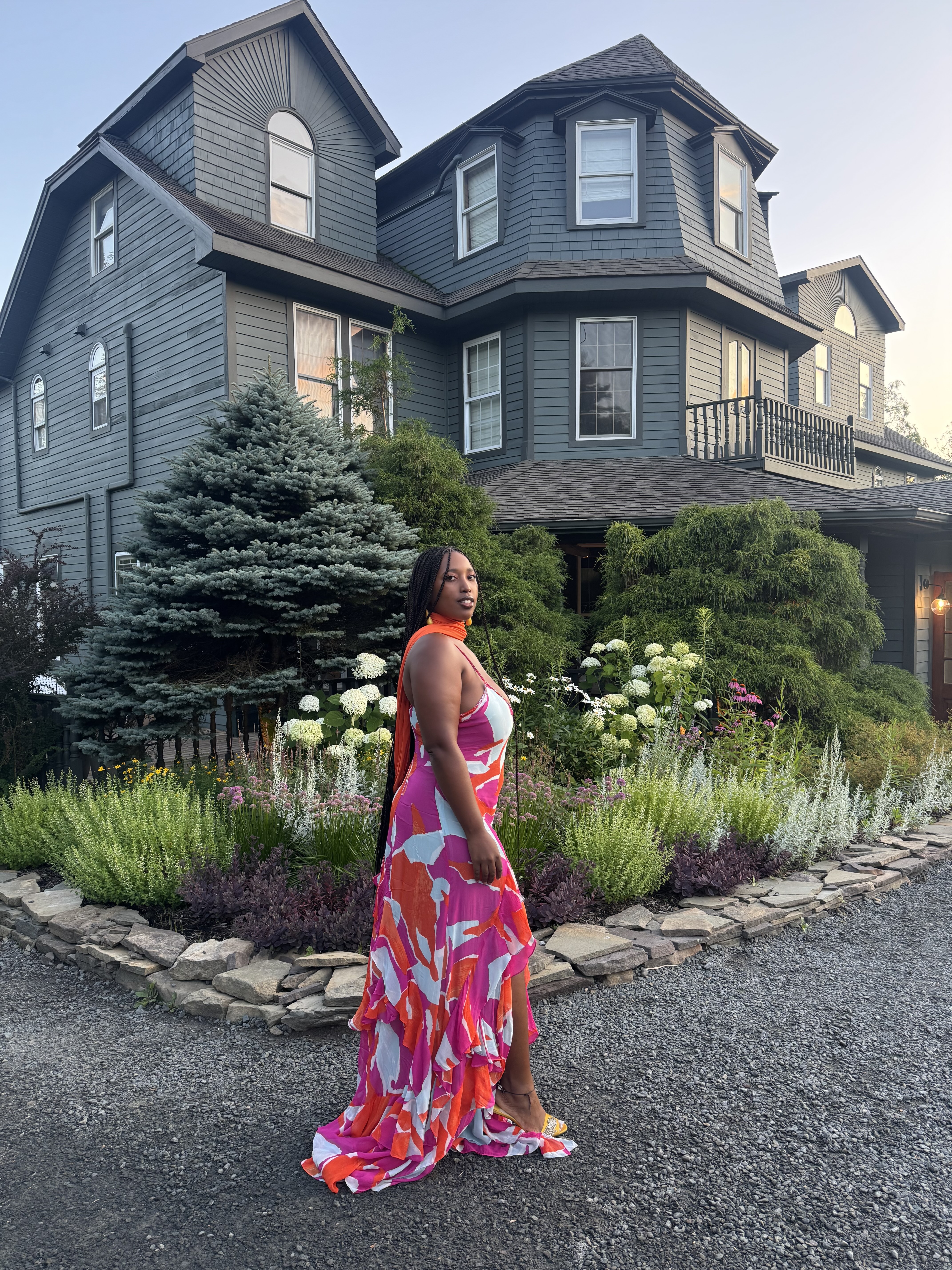 Mecca James-Williams wearing a pink, red, and white floral dress at a wedding