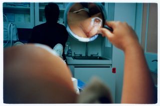 Breast surgery seen in hand-held mirror