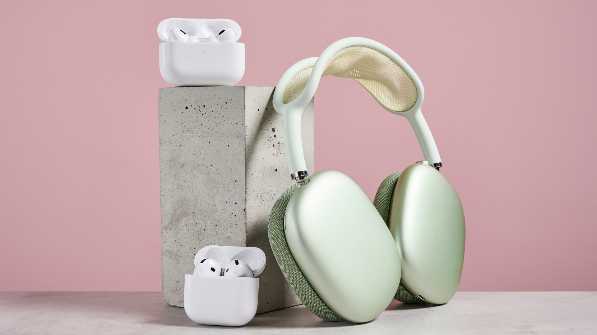AirPods Pro 2, AirPods 4 and AirPods Max arranged together on a desk