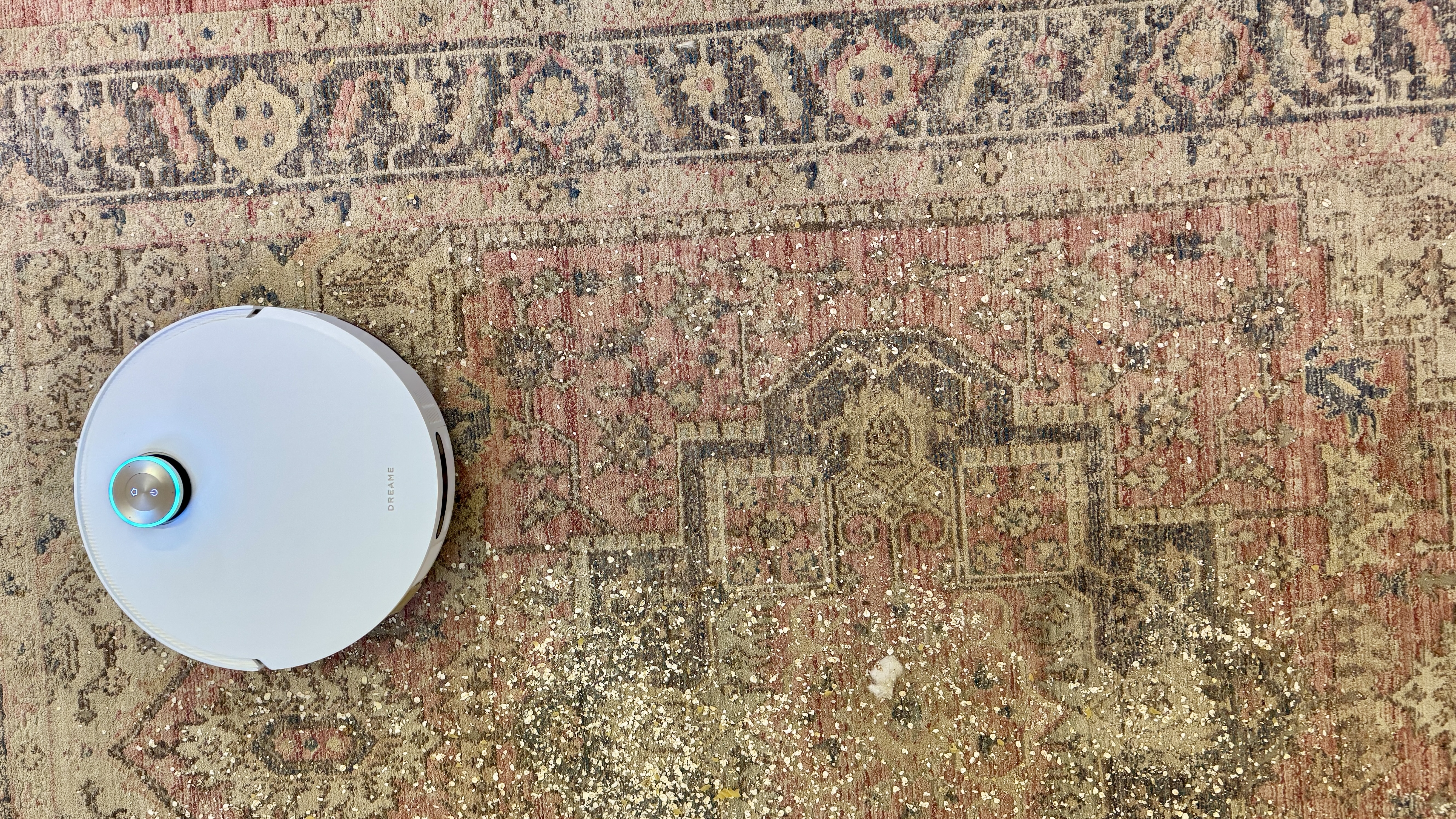 Dreame Matrix10 Ultra robot vacuum cleaning debris from a large rug