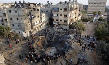 Palestinians gather around a destroyed house after an Israeli air strike in Khan Younis in the southern Gaza Strip on Nov. 19.