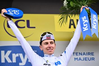 UAE Team Emirates' Slovenian rider Tadej Pogacar celebrates on the podium with the best young rider's white jersey after the 11th stage of the 110th edition of the Tour de France cycling race, 180 km between Clermont-Ferrand and Moulins, in central France, on July 12, 2023. (Photo by Marco BERTORELLO / AFP)