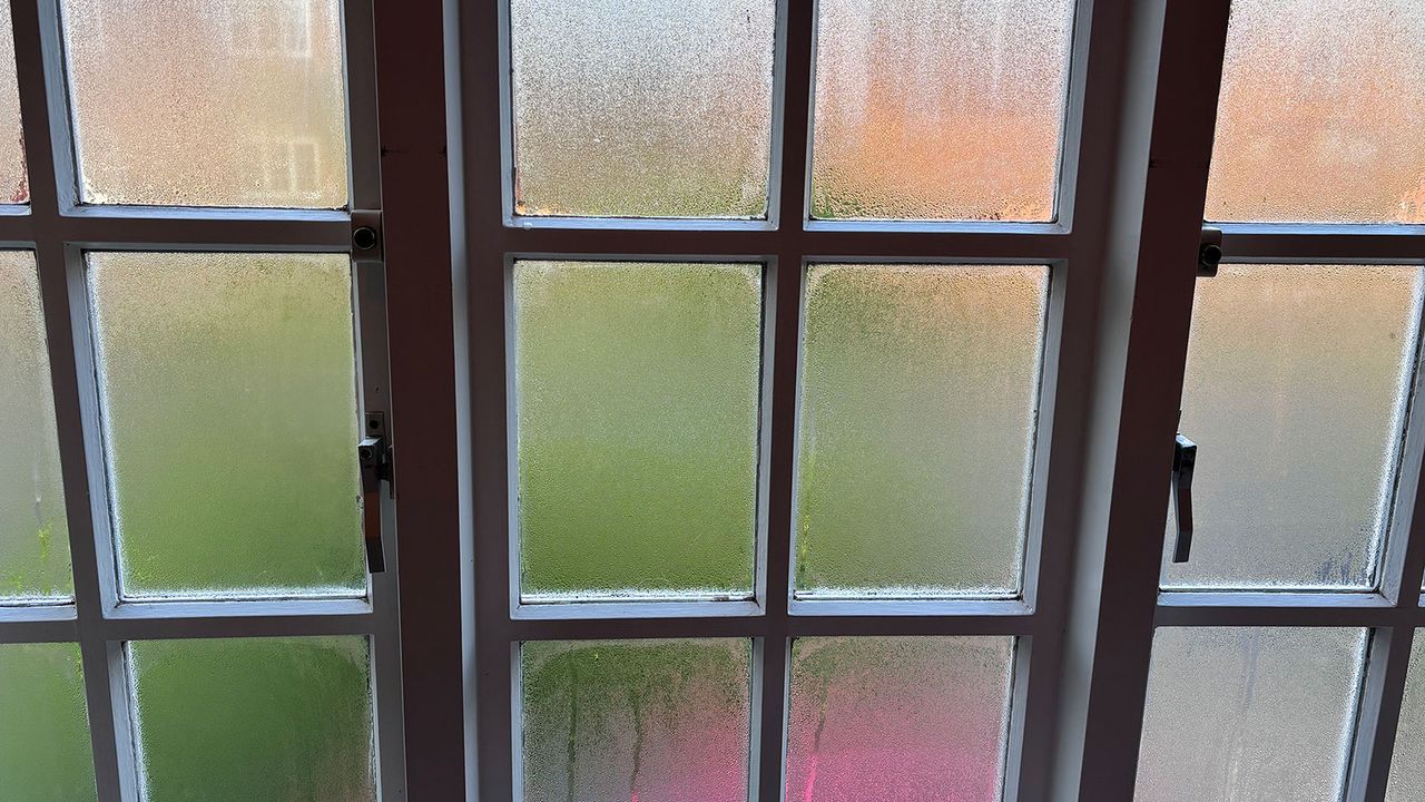 paned casement window with condensation