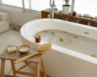 Bathtub with scrub brush and candles