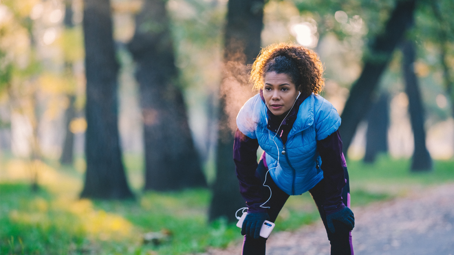 Woman exhaling while exercising in cold weatehr