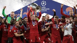 Liverpool players celebrate with the Champions League trophy after victory over Tottenham in the 2019 final in Madrid.