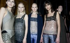 Female models dressed Paco Rabanne A/W 2015 collection backstage of the fashion show