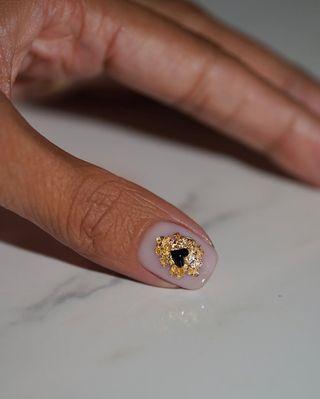 Heart-shaped, gold accent manicure by Iram Shelton