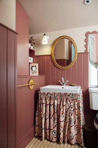 Coral pink bathroom with skirt around sink