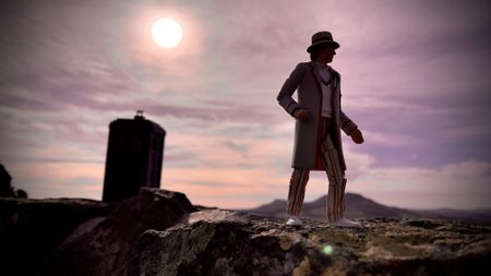 Doctor Who toy standing in front of the Tardis lit by a setting sun