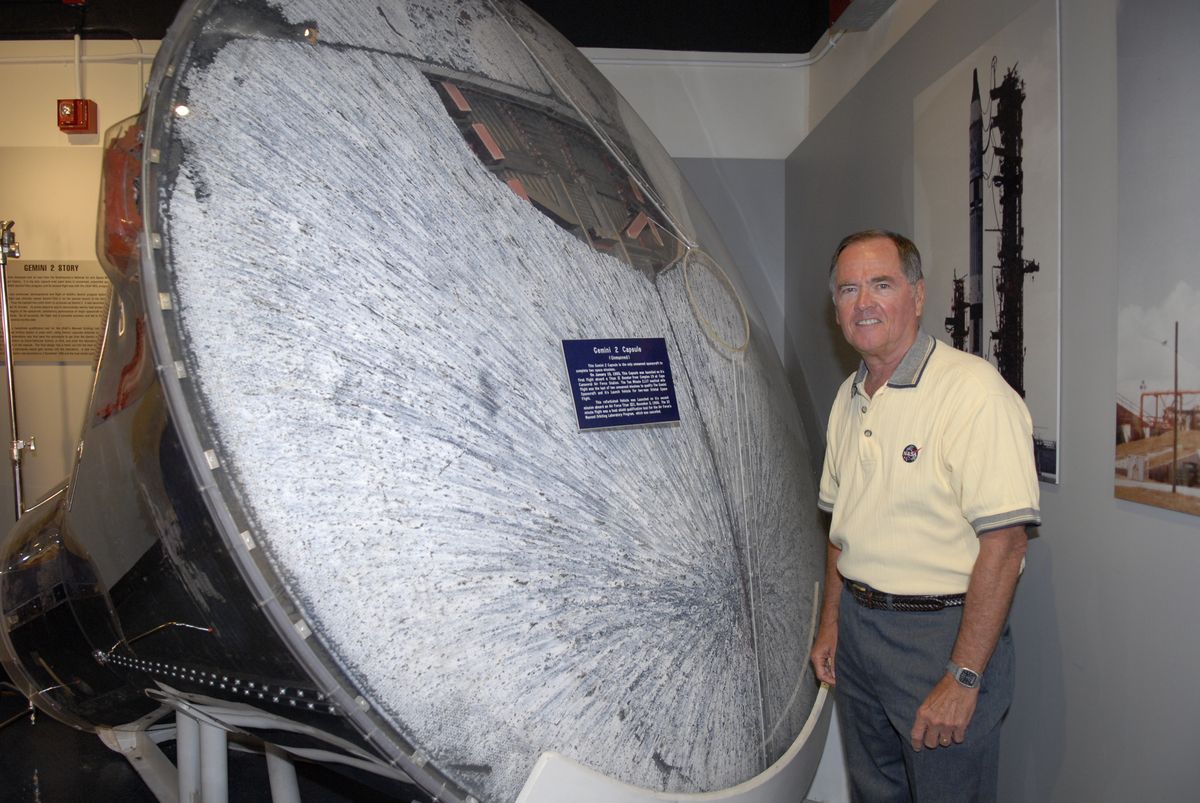 Former MOL astronaut Robert Crippen poses with the re-flown Gemini 2 spacecraft used in the November 1966 Gemini-B Heat Shield Qualification Test, on display at the Air Force Space and Missile Museum in Cape Canaveral. Note the 26-inch diameter crew transfer hatch cut into the Gemini's heat shield. Crippen eventually flew as a NASA astronaut, piloting the first space shuttle mission (STS-1) in 1981, and commanding three more shuttle missions. He later served as director of NASA's Kennedy Space Center.