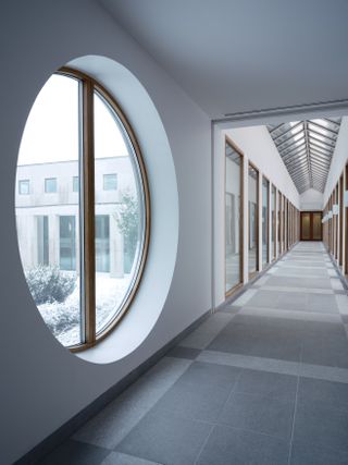 Round window in corridor at Polestar Design Studio, Sweden