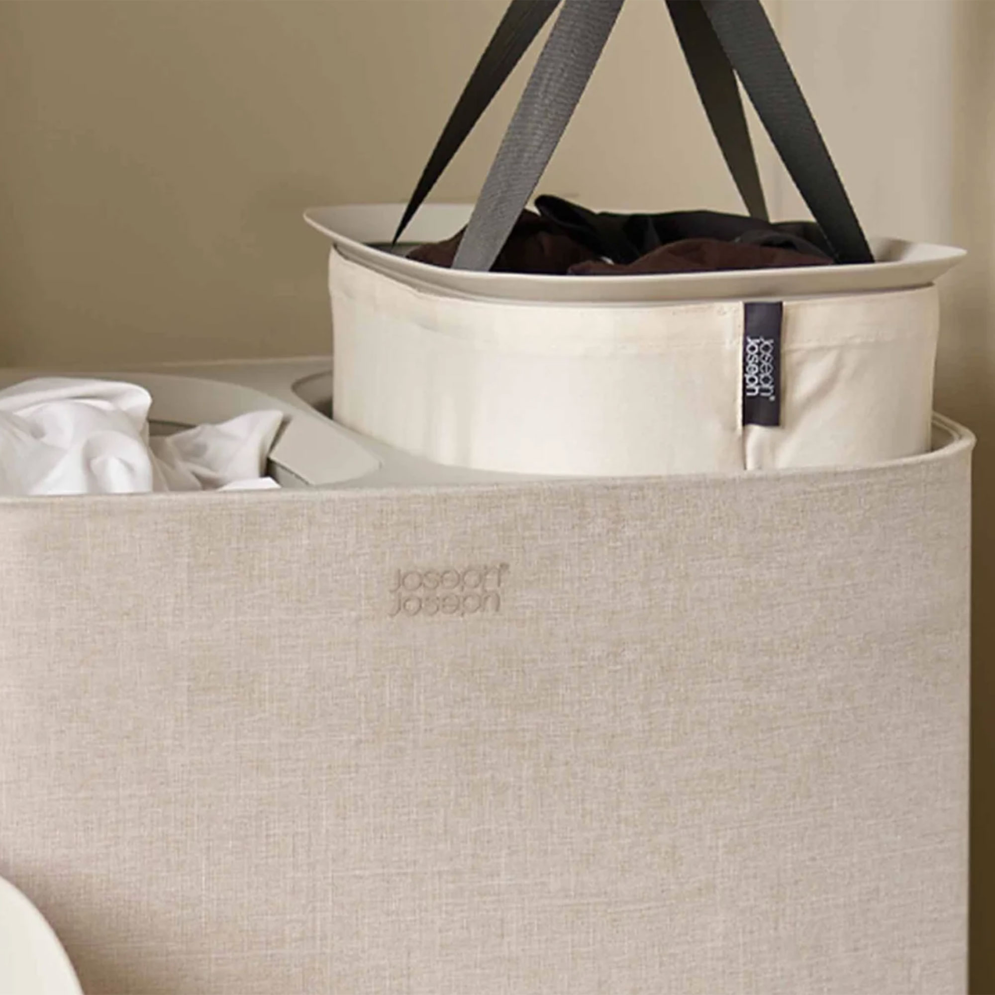 Ecru Joseph Joseph Tota laundry basket with one section being pulled out