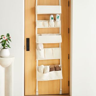 Over-The-Door Hanging Organizer over a wooden door. 